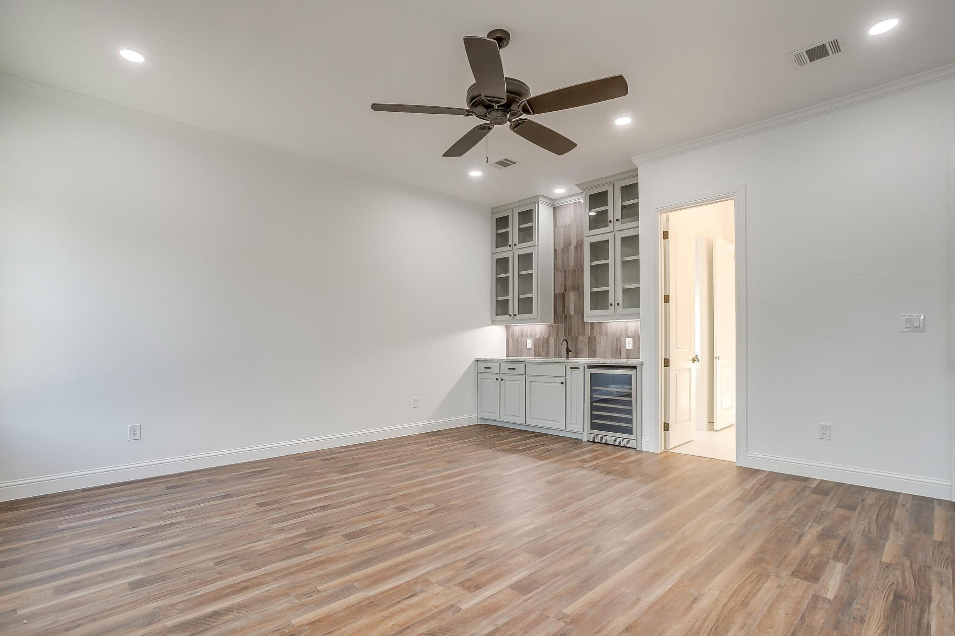 Game room with a built-in wet bar and wine refrigerator