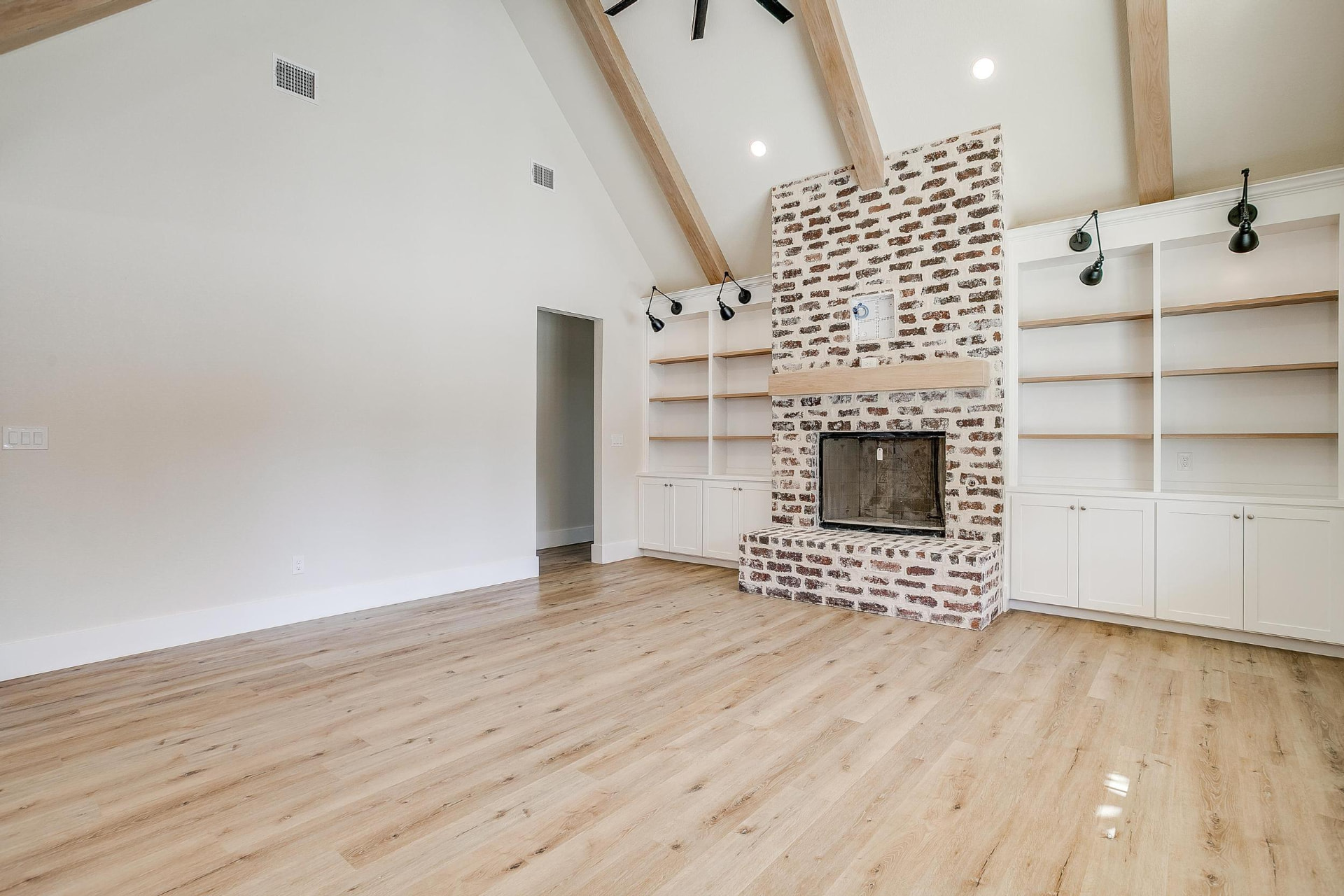 Living space with light wood flooring and clean white walls