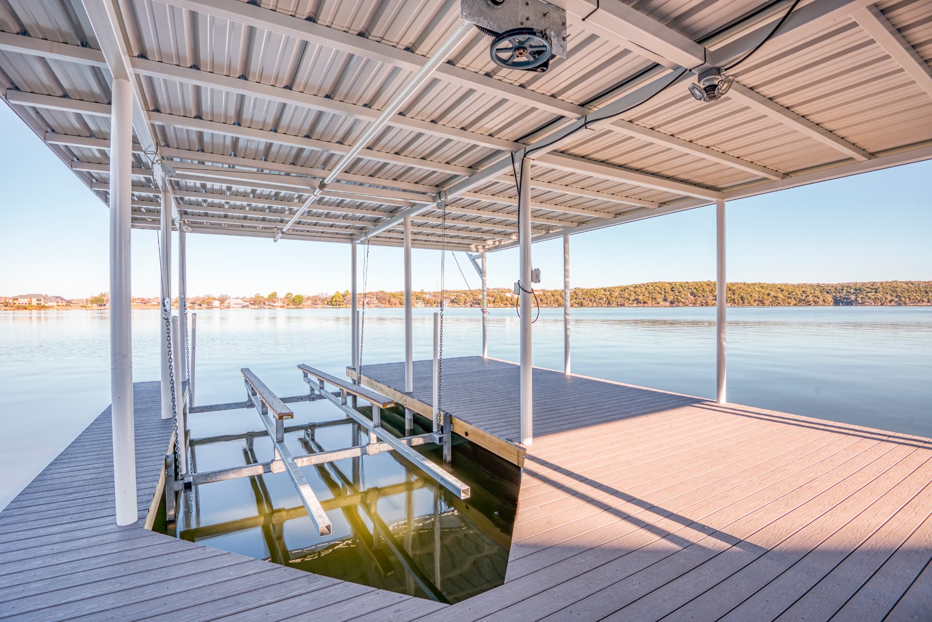 Covered metal boat dock with lift on Lake Granbury