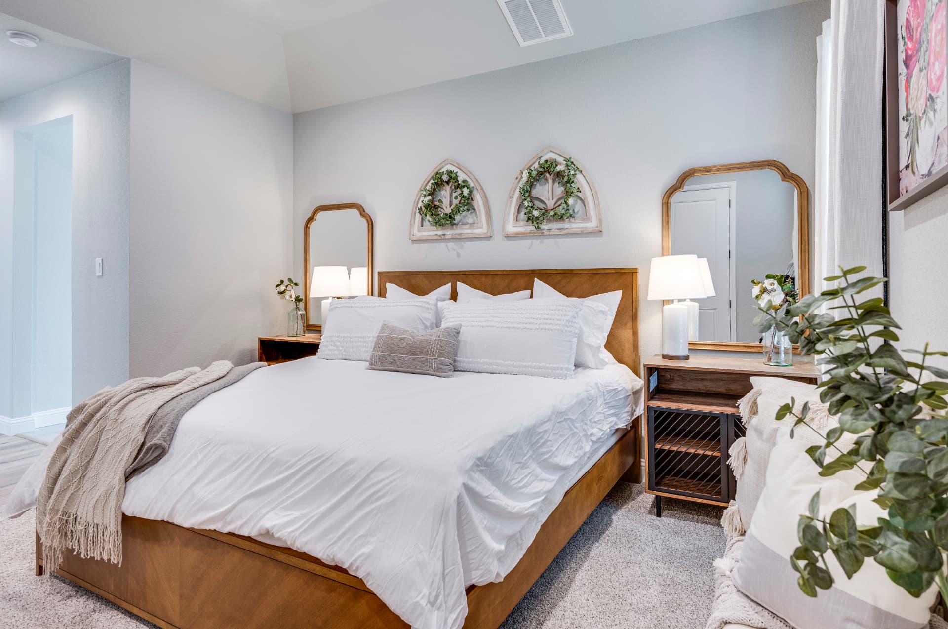 Bedroom with symmetrical nightstands and mirrors