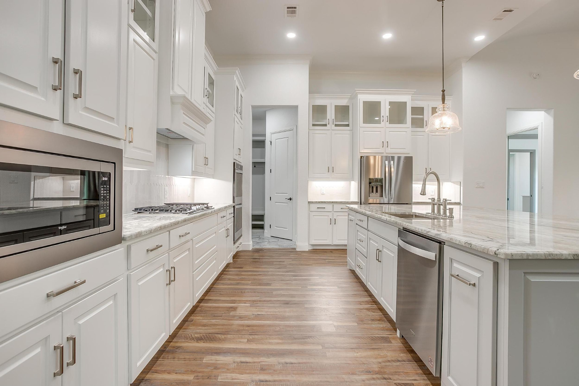 Long view down the kitchen galley and island