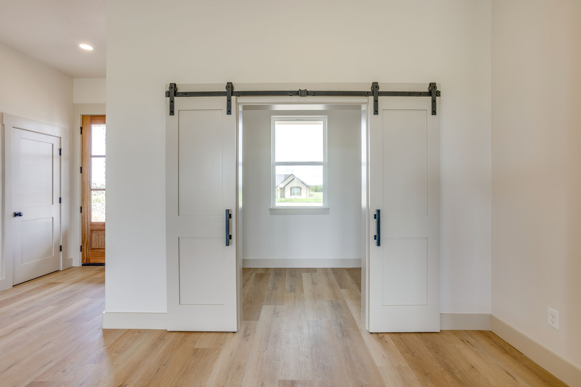Front office viewed through open white barn doors