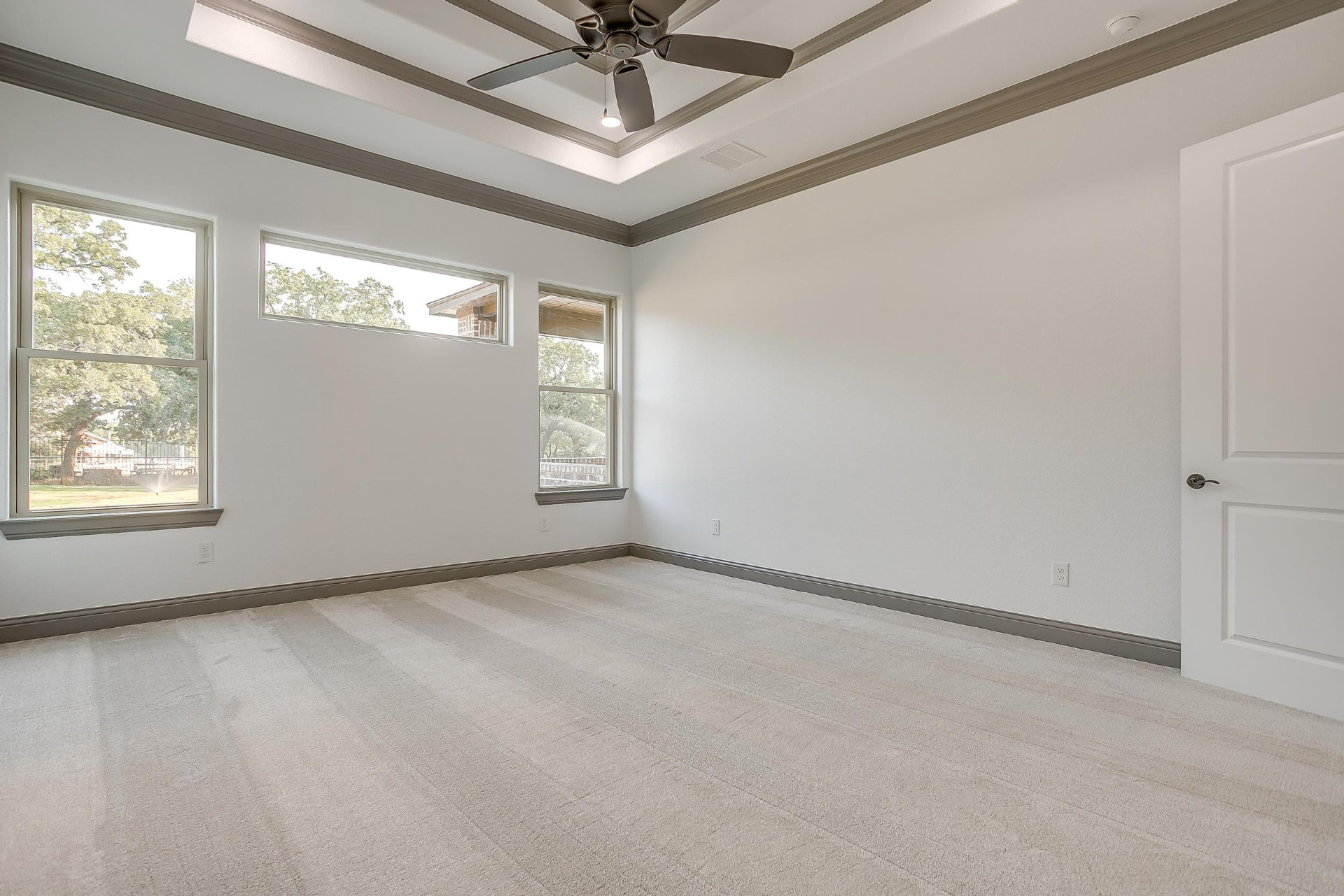 Wide view of the carpeted primary bedroom
