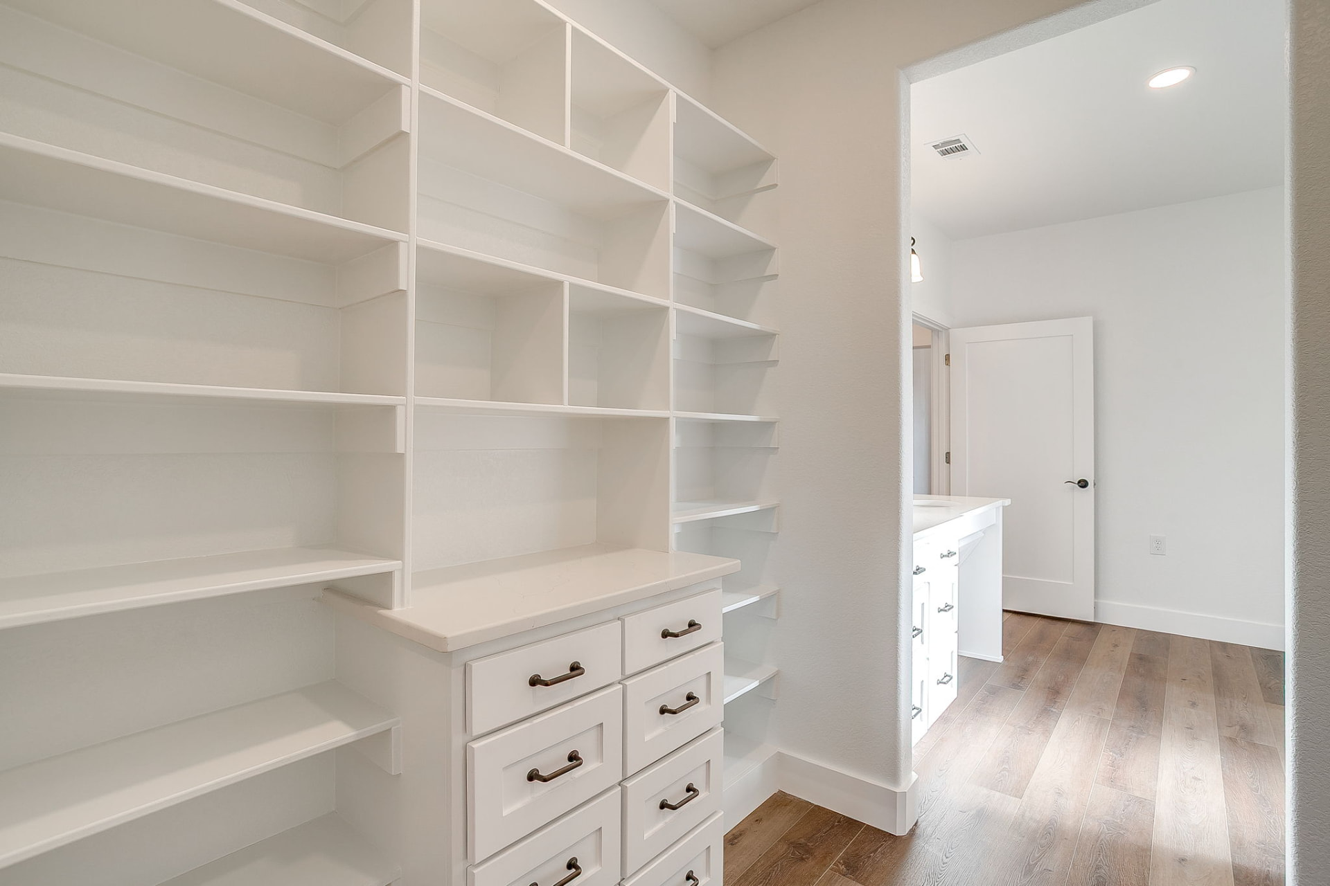 Bedroom closet with hanging rods and cubbies