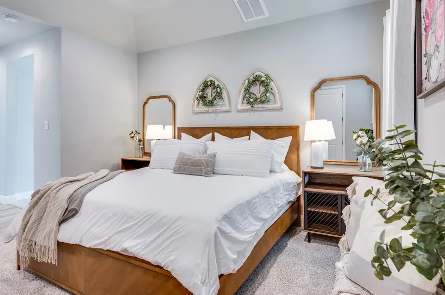 Bedroom with symmetrical nightstands and mirrors
