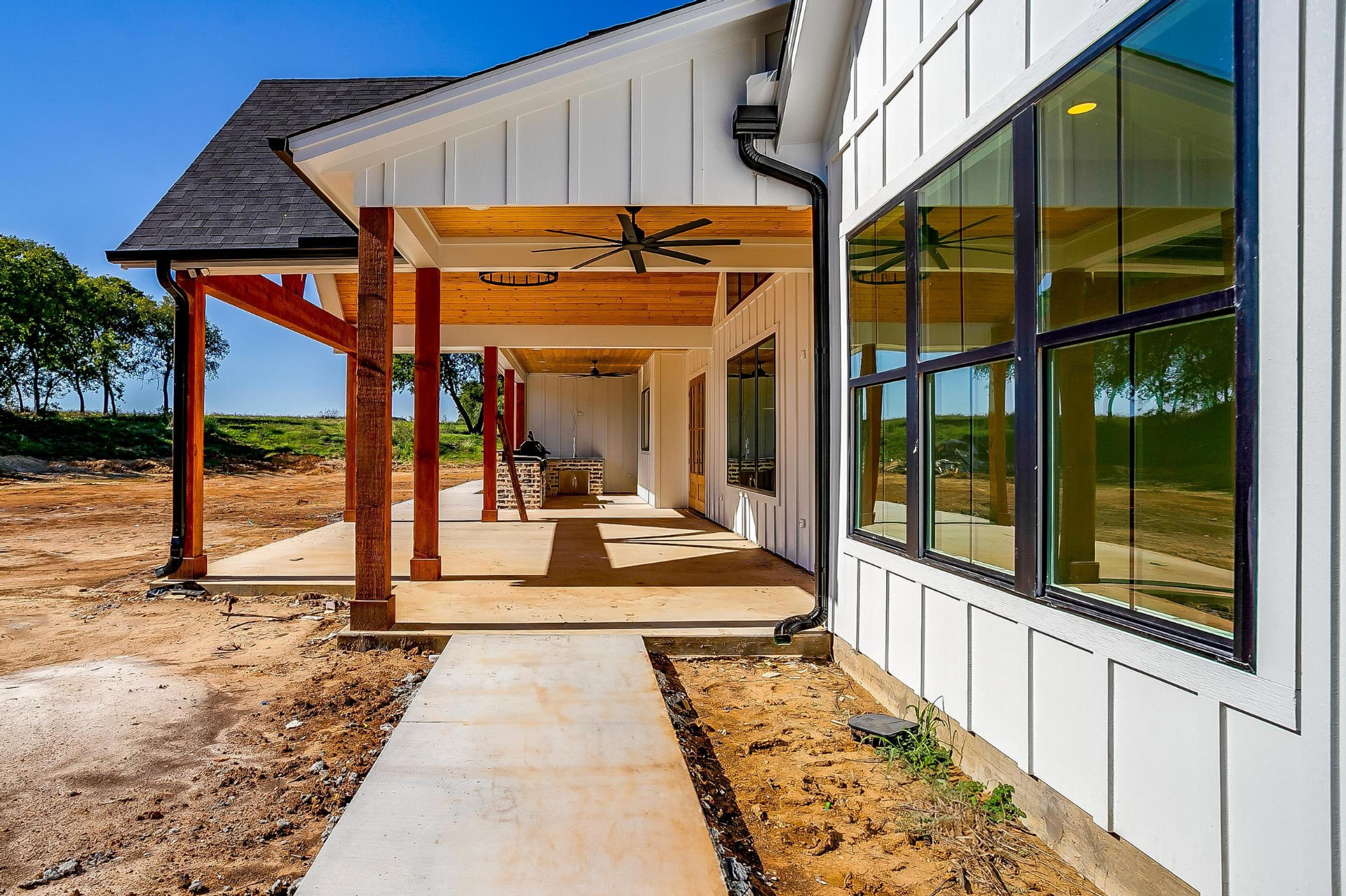 Rear elevation with a long covered porch and cedar columns