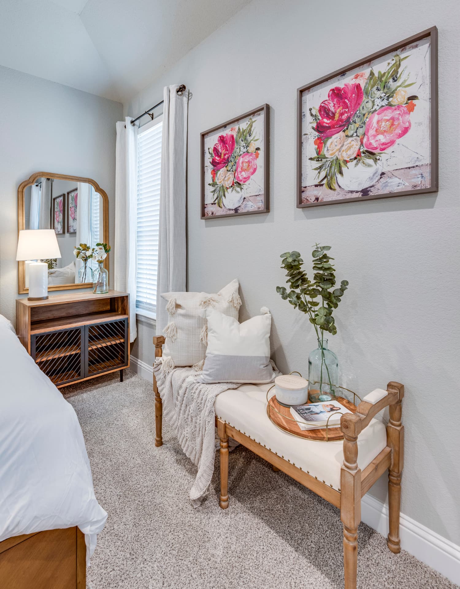 Bedroom corner with wood bench and vanity mirror