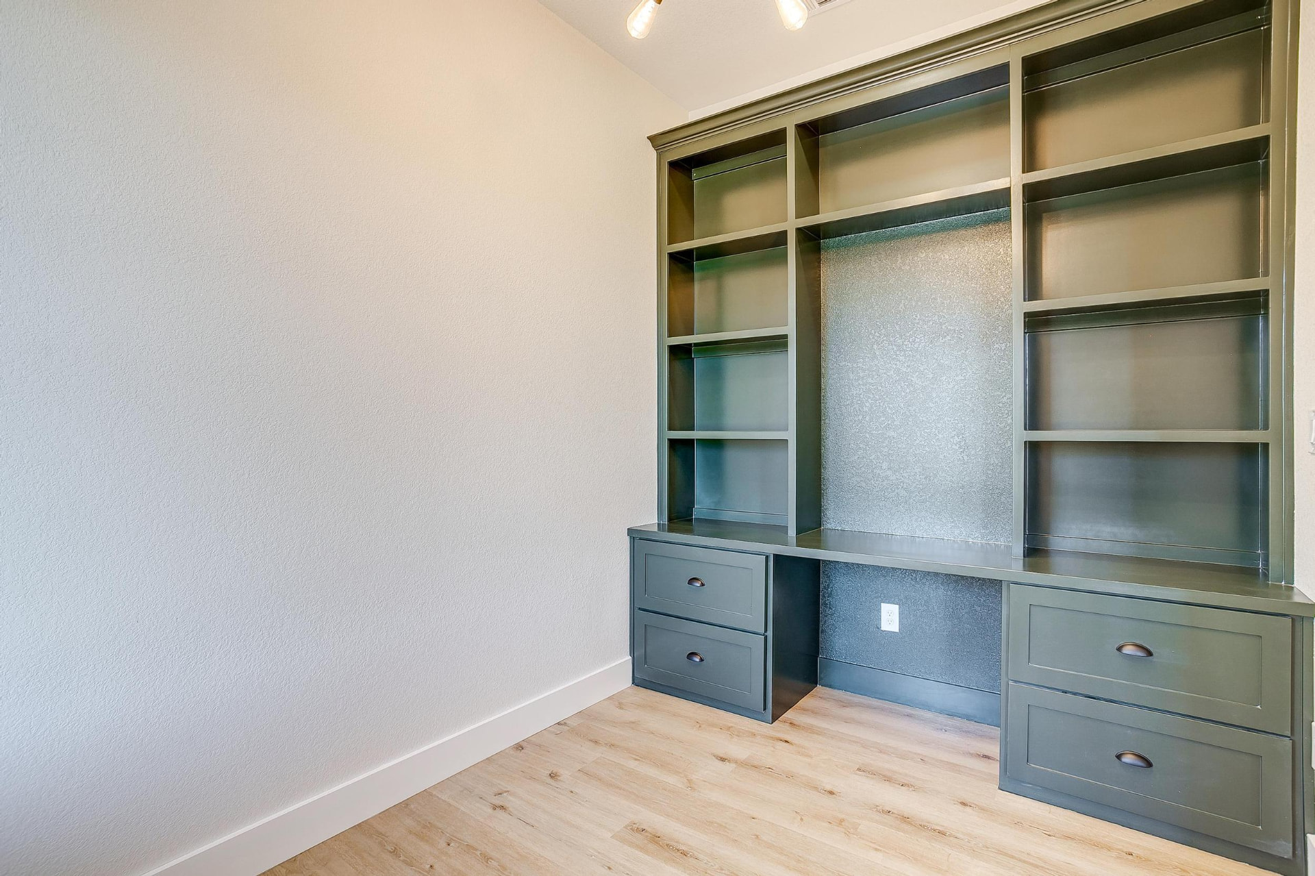 Built-in home office desk and shelving in deep charcoal green