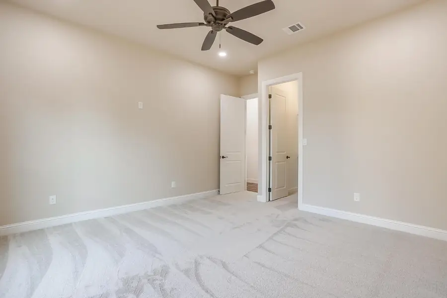 Secondary bedroom with natural light and neutral finishes