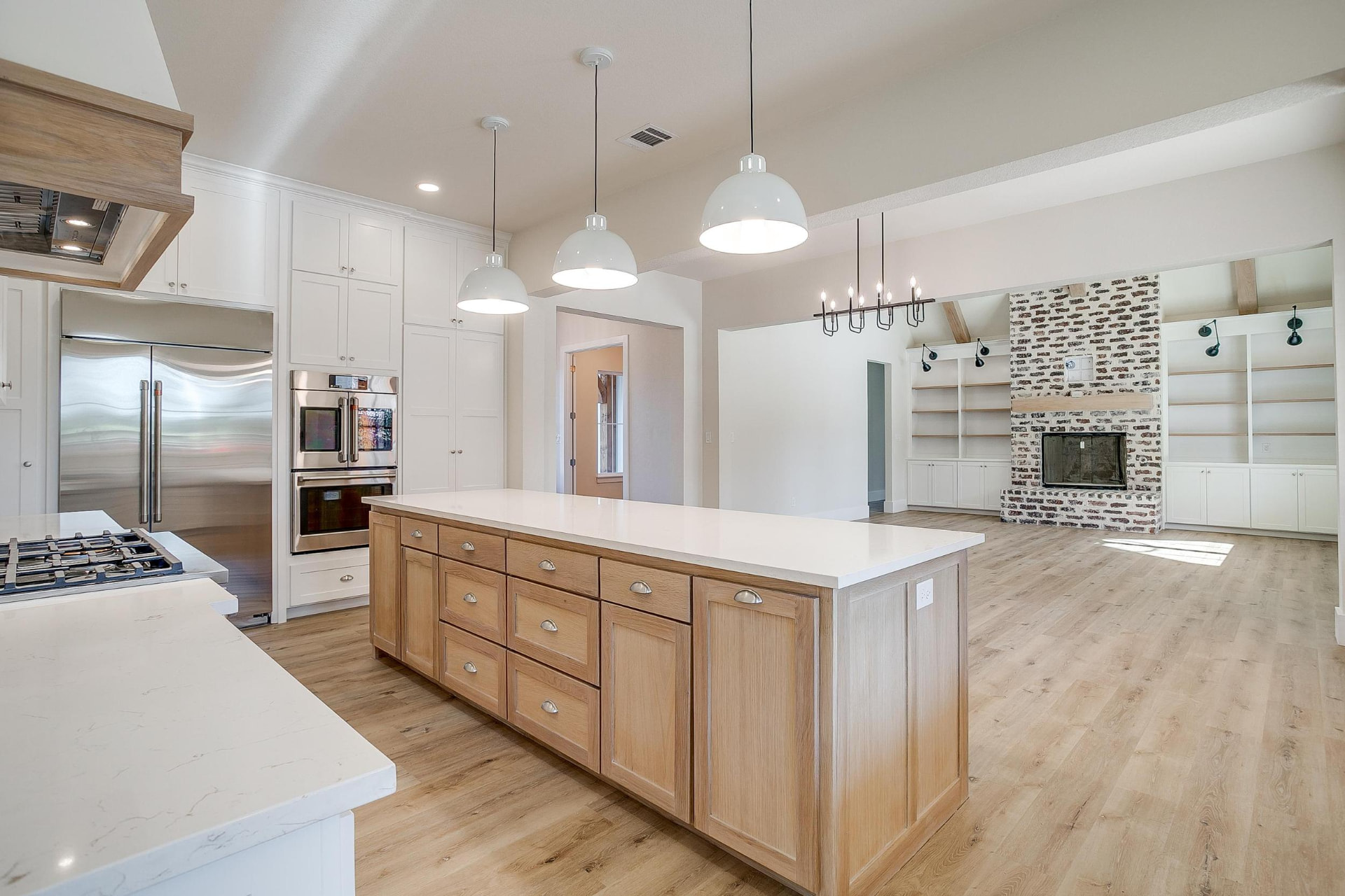 Kitchen island with deep wood drawers and the living area beyond