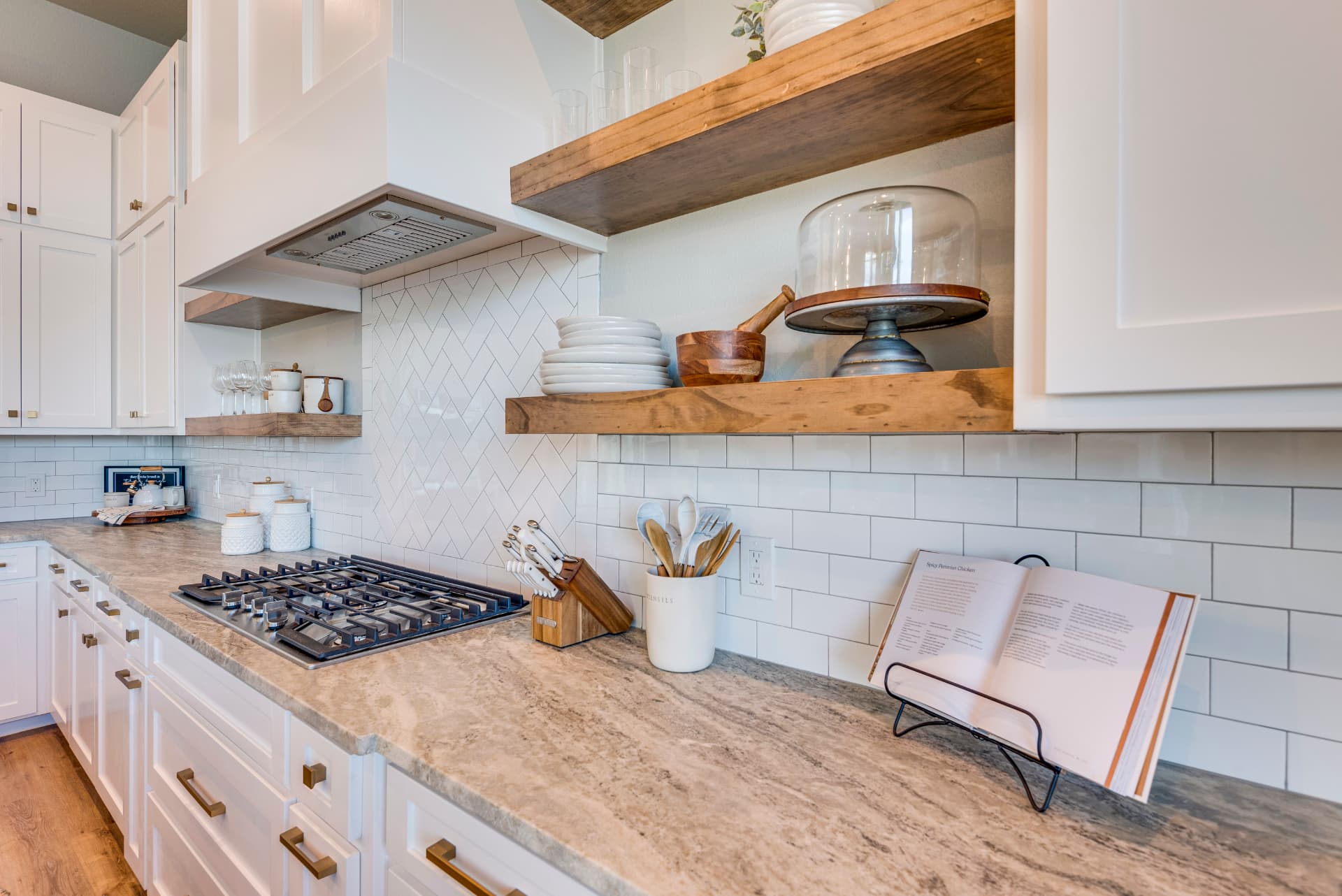 Range wall with floating wood shelves in the kitchen