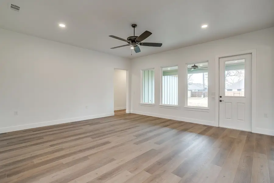Great room and dining area with large windows and natural light