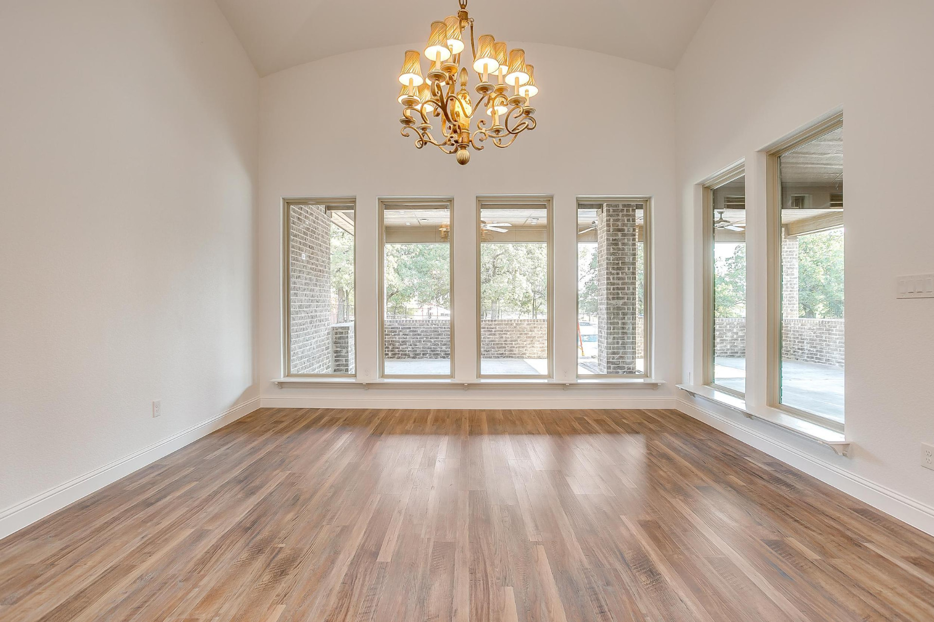 Dining area with vaulted ceiling and iron chandelier