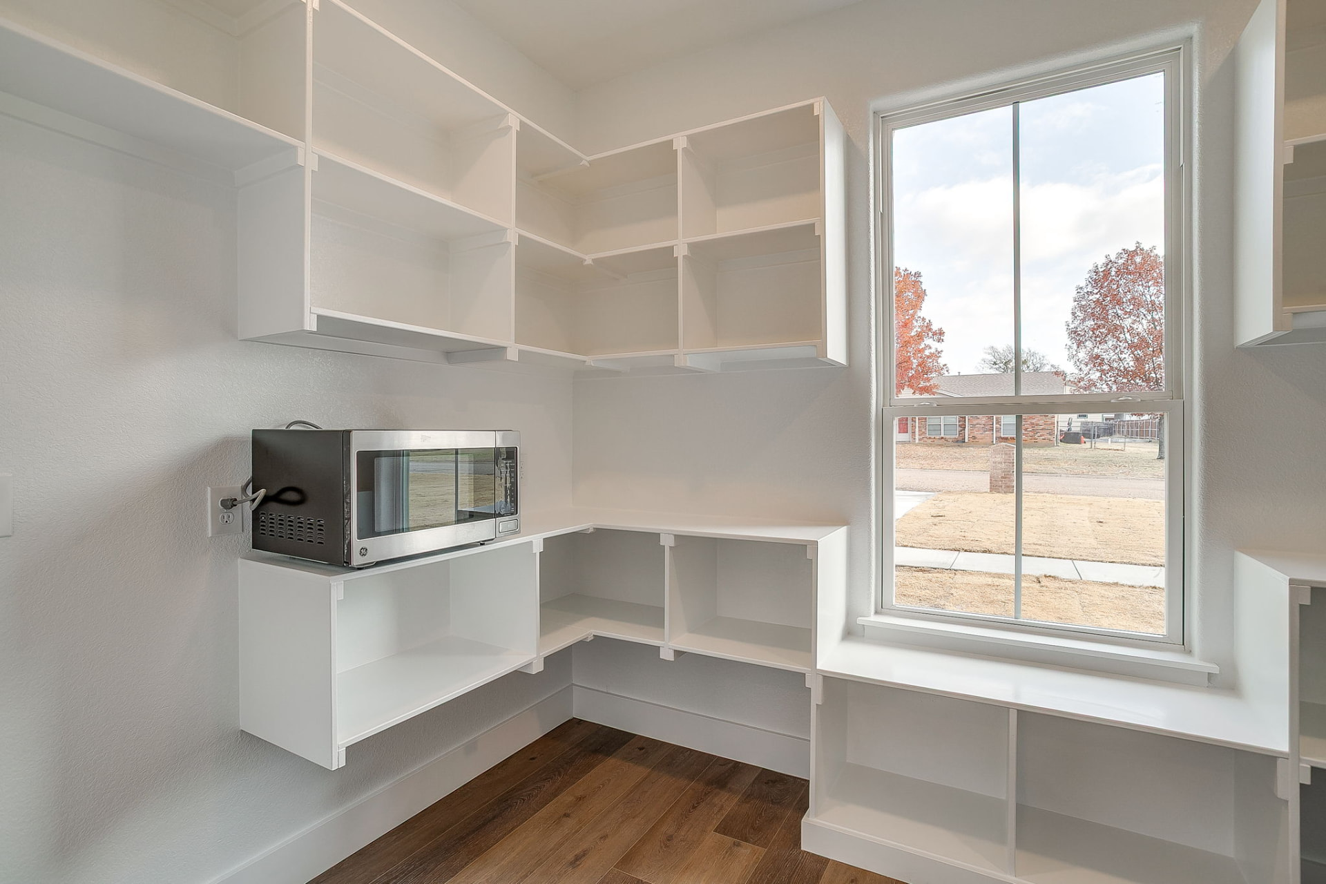 Secondary bedroom with large window and neutral finishes