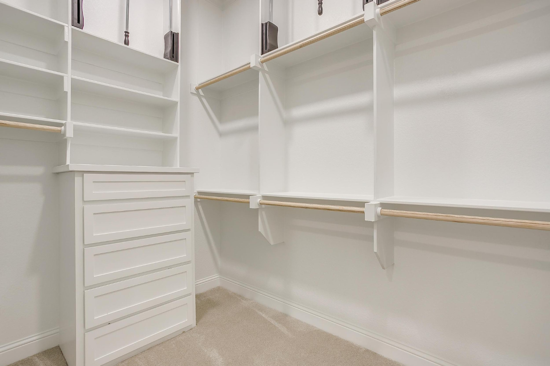 Second walk-in closet with built-in drawer tower and shelving