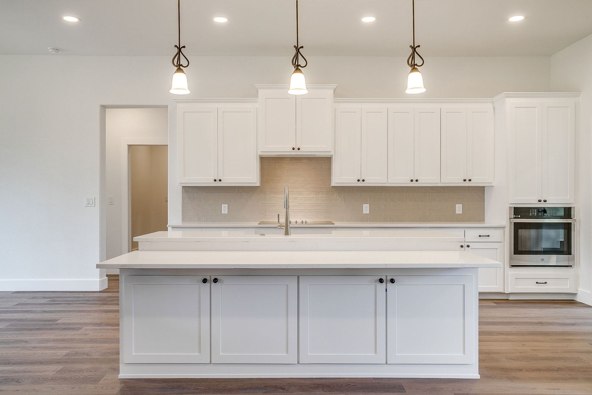 Kitchen range wall with custom vent hood and tile backsplash