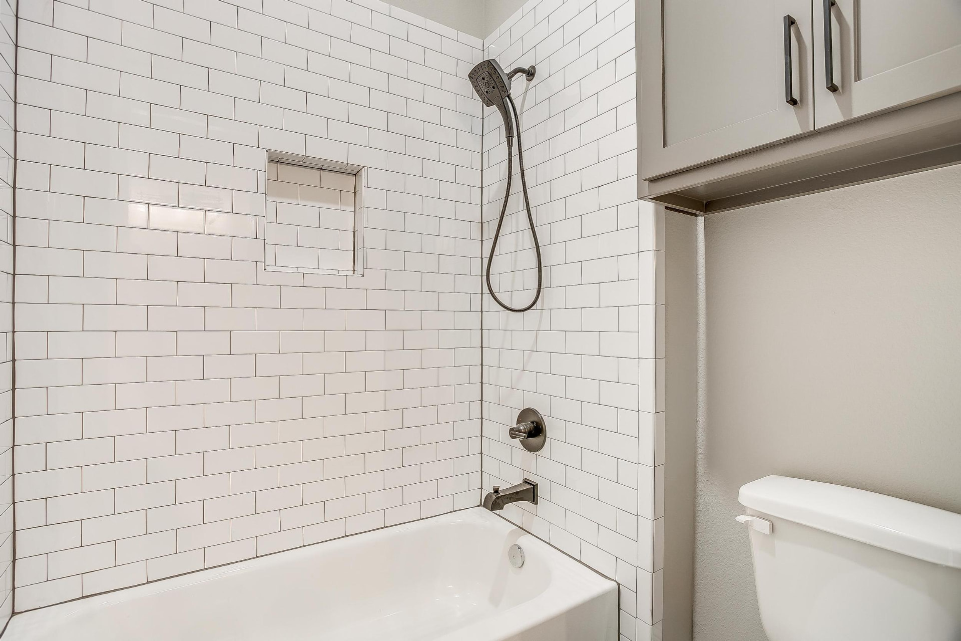 Tub and shower combination with white subway tile