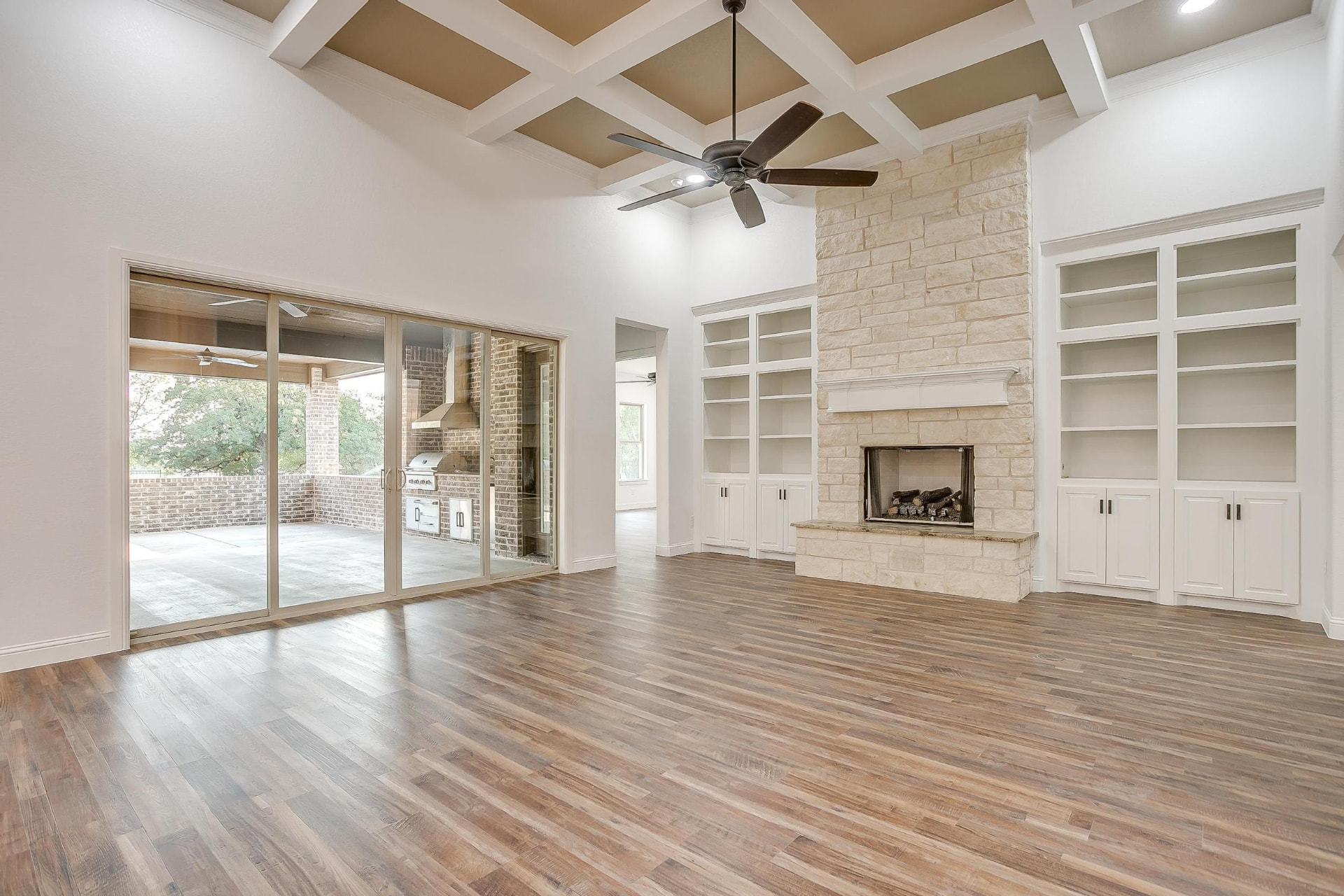 Great room with coffered ceiling and tall windows
