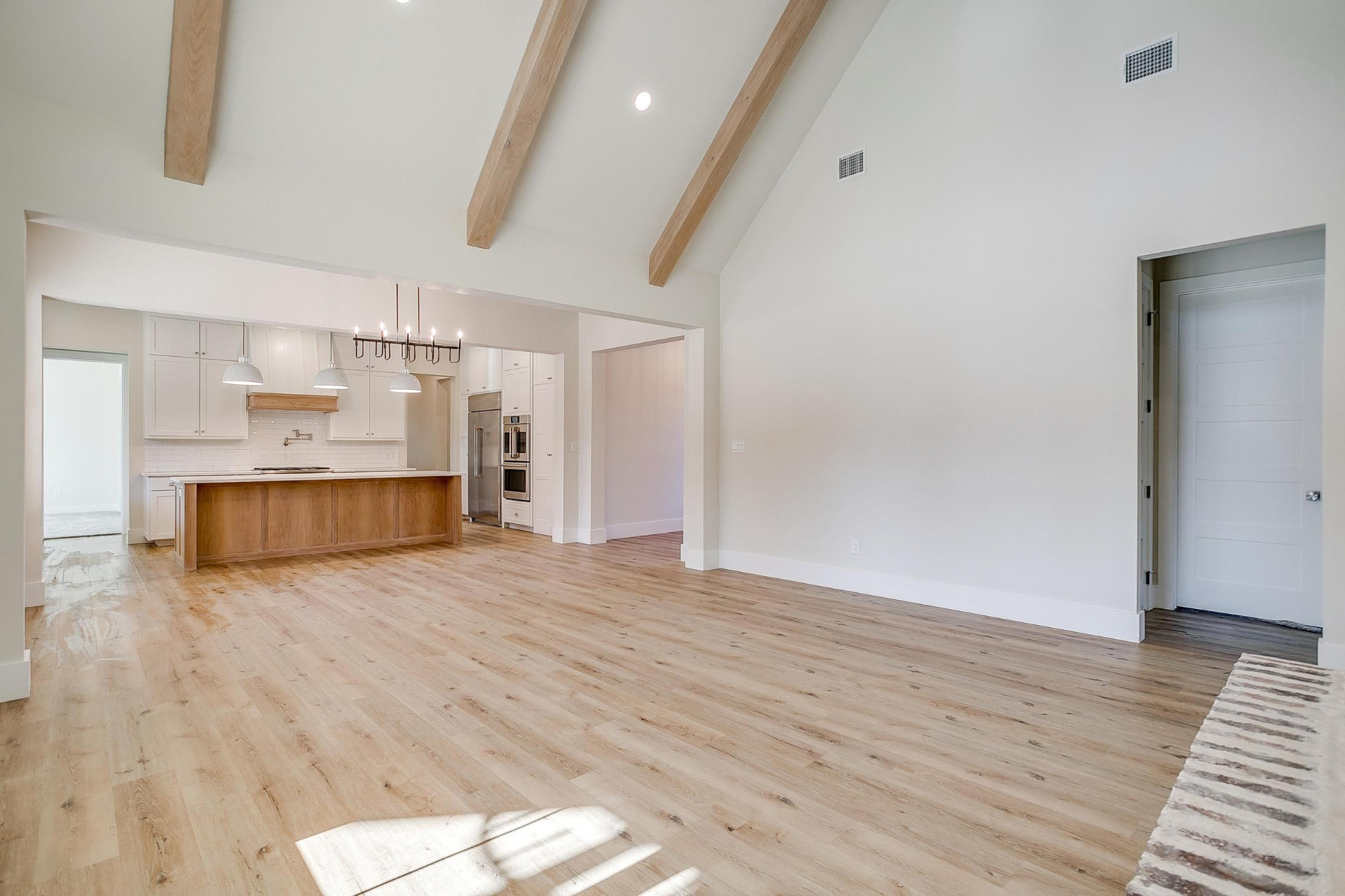 Open-concept living room looking into the kitchen with a wood island