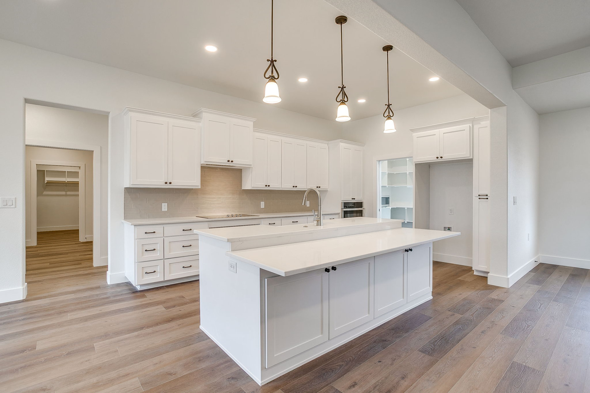 Quartz countertops and cabinet hardware detail in the custom kitchen