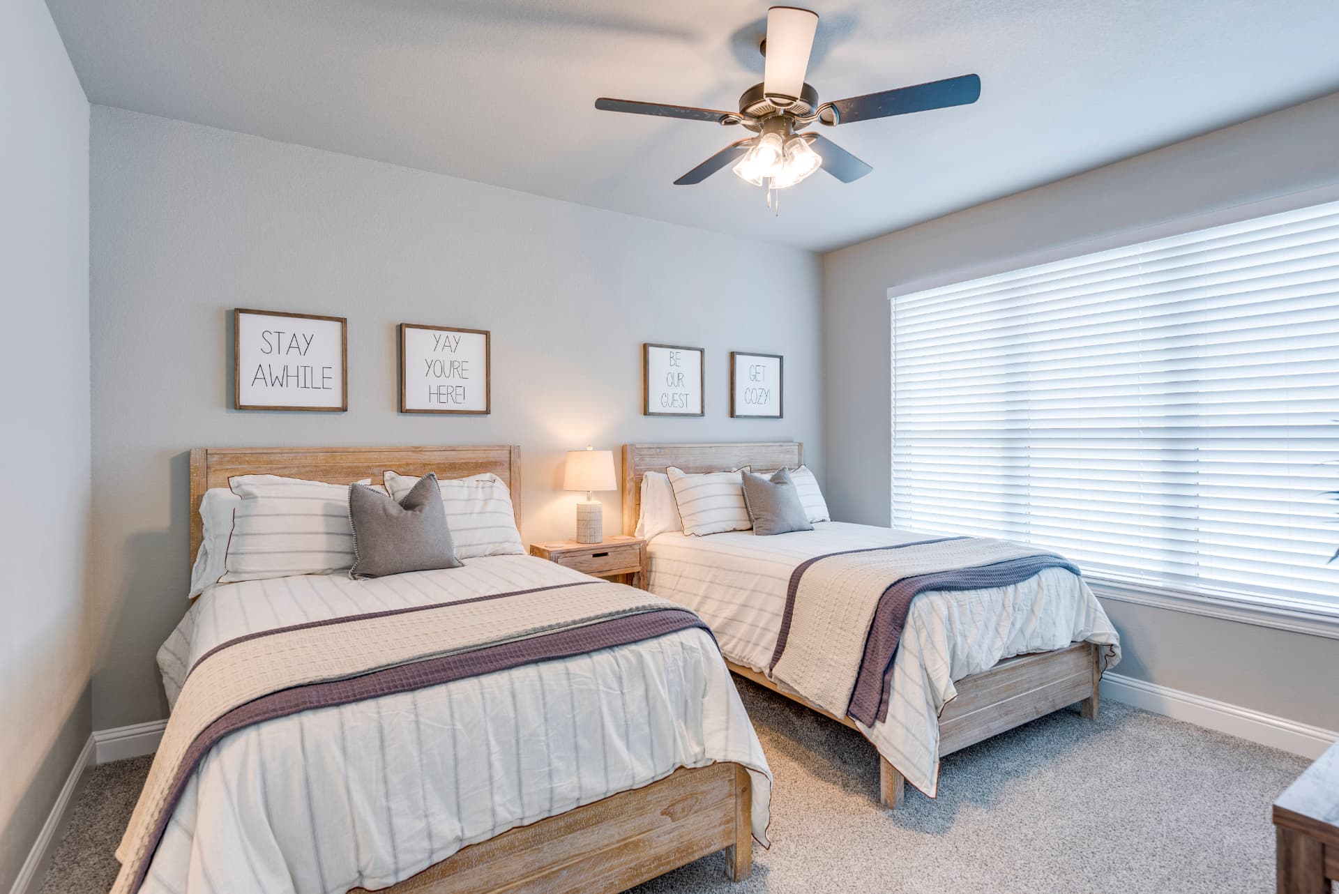 Guest bedroom with twin beds and playful wall art