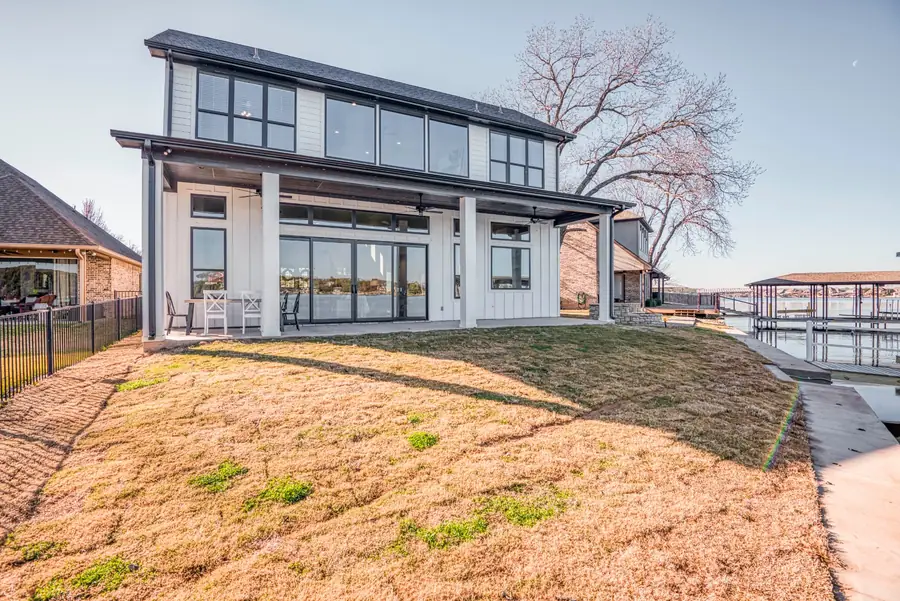 Side exterior with a grassy slope down to the lake