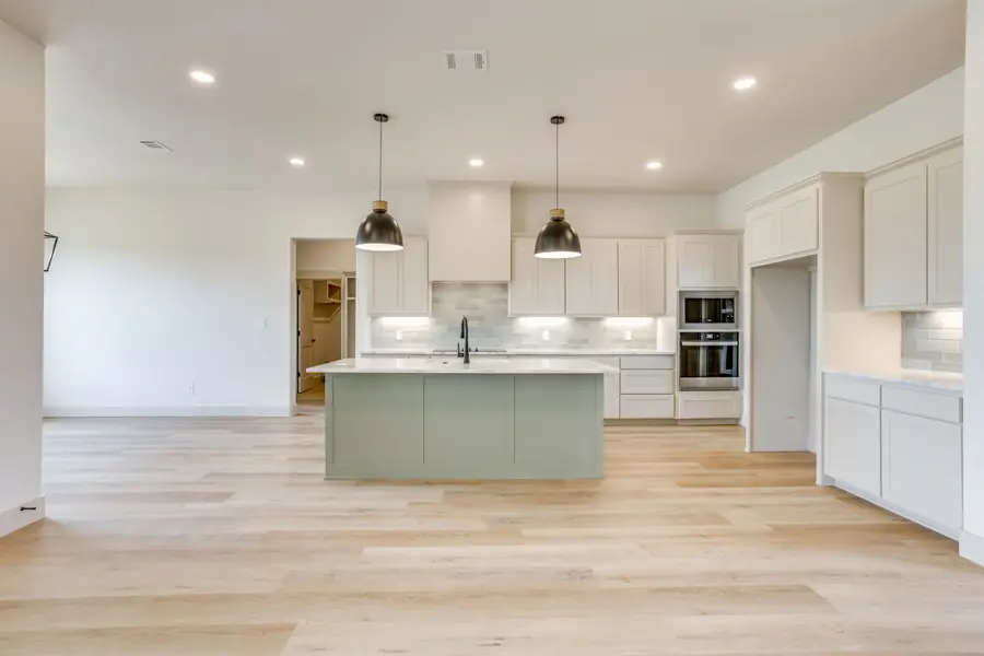 Wide view of the open-concept kitchen and living space