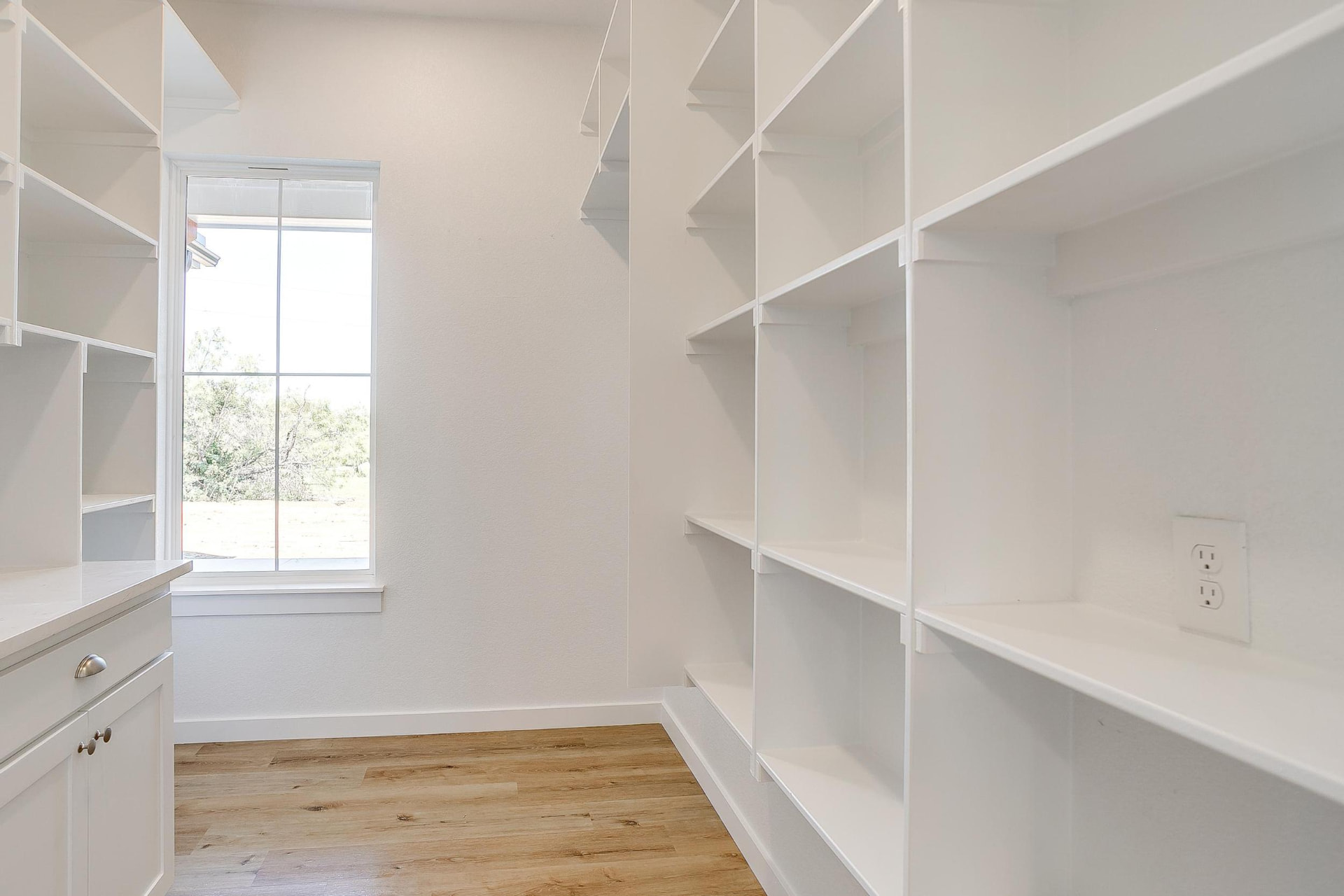 Primary closet with floor-to-ceiling built-in shelving