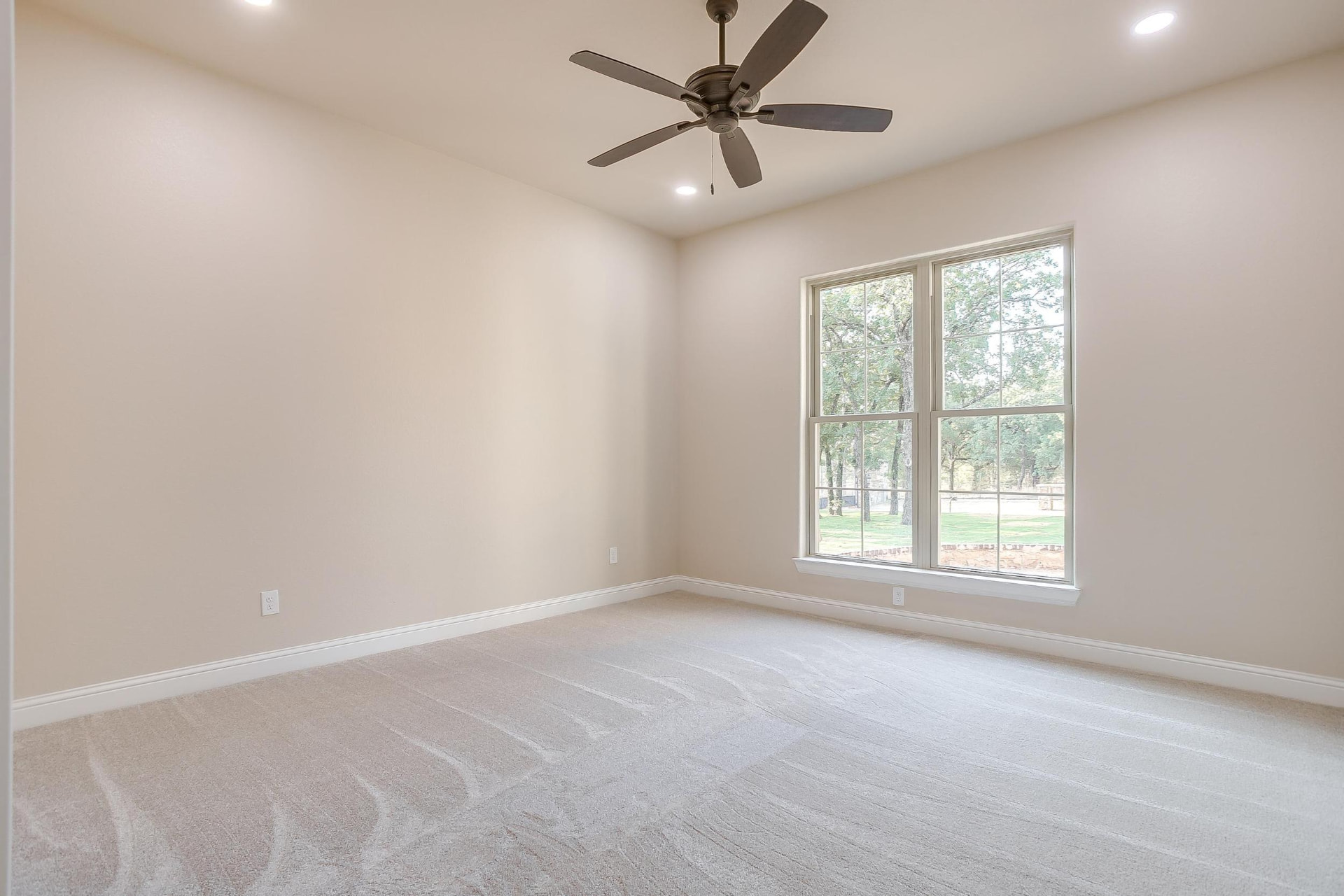 Bedroom with plush carpet and ceiling fan