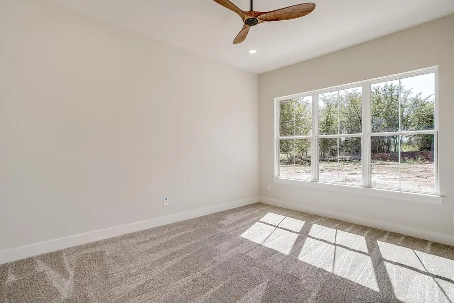 Bright bedroom with natural light and neutral walls