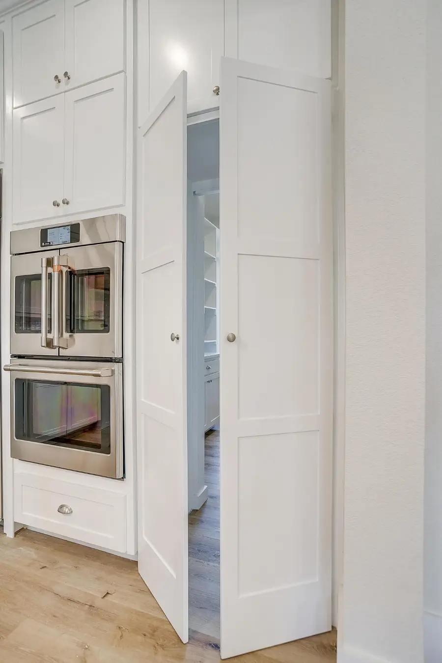 Walk-in pantry with white shelving