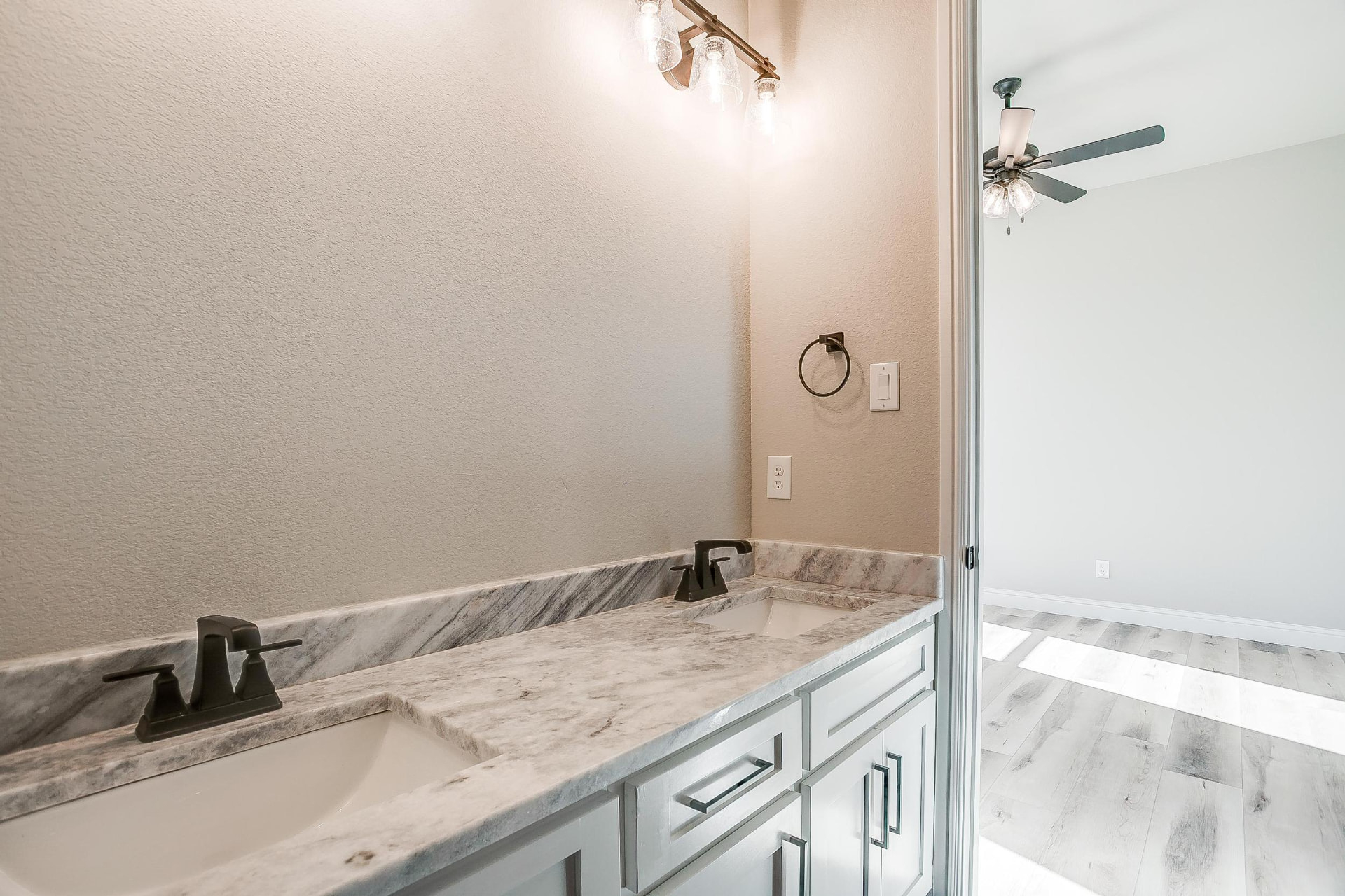 Guest bath double vanity with marble top and black fixtures