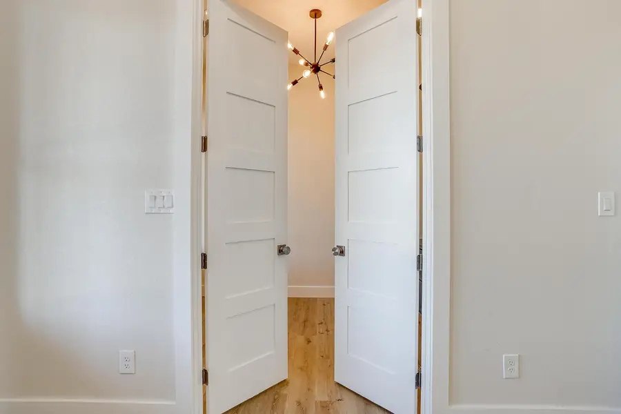White double doors opening into the lit home office