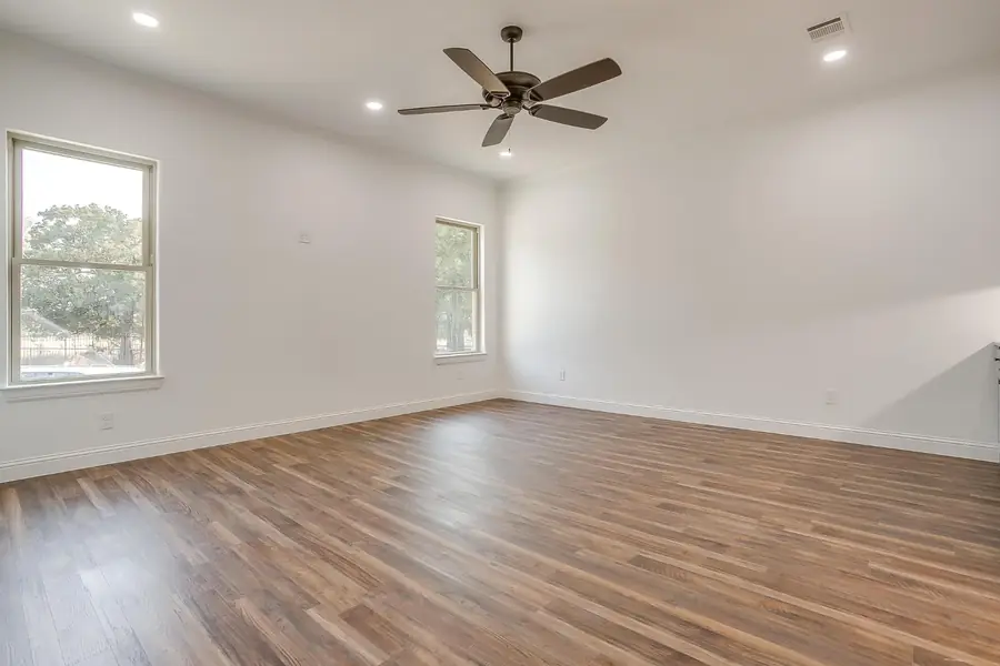 Game room with dark wood flooring and ceiling fan