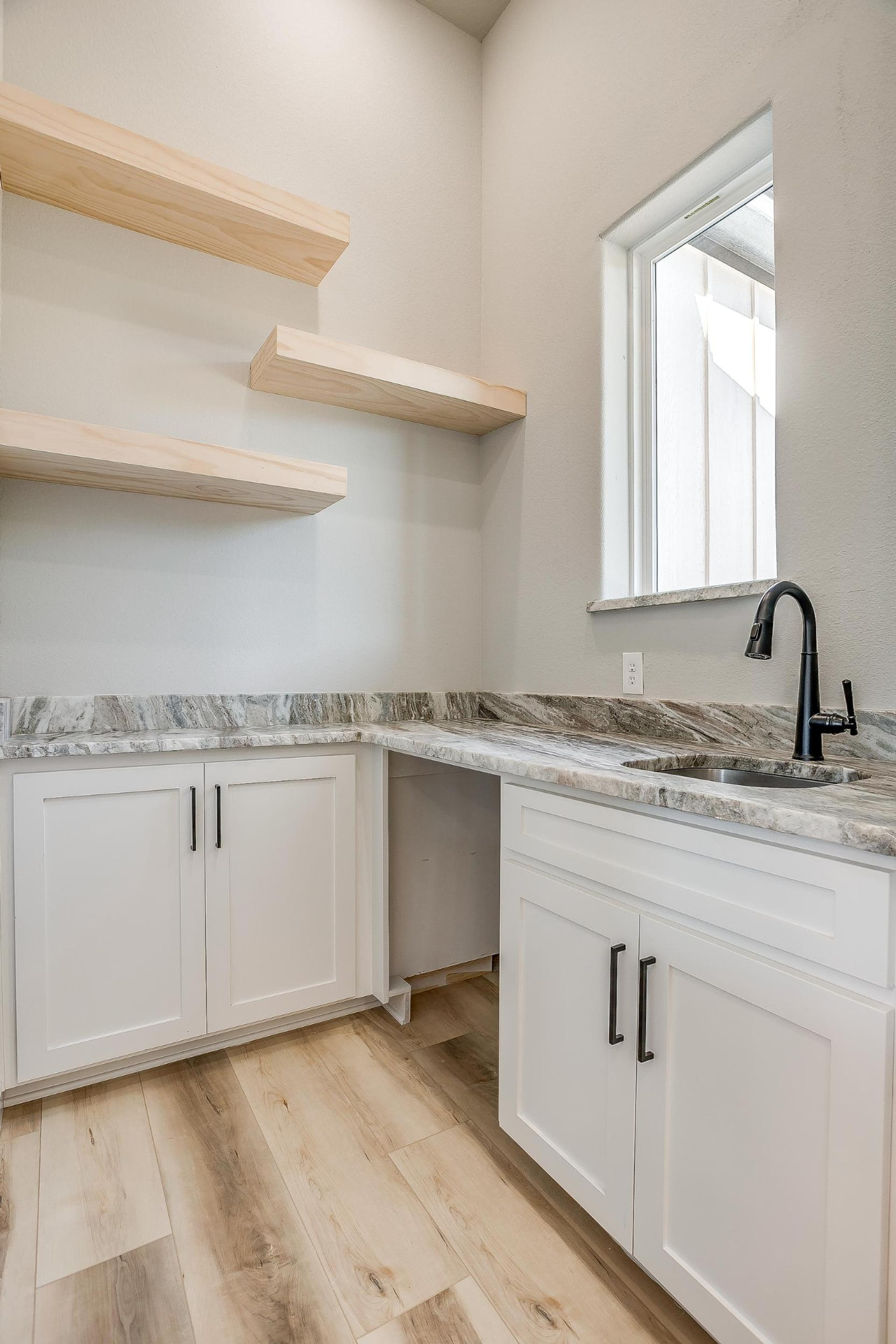 Prep room sink with open wood shelving