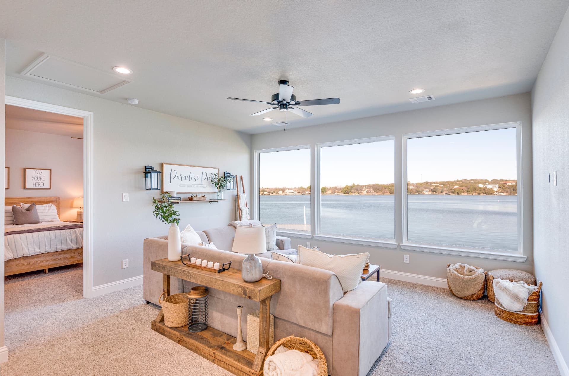 Upstairs lounge with sofa facing the lake-view windows