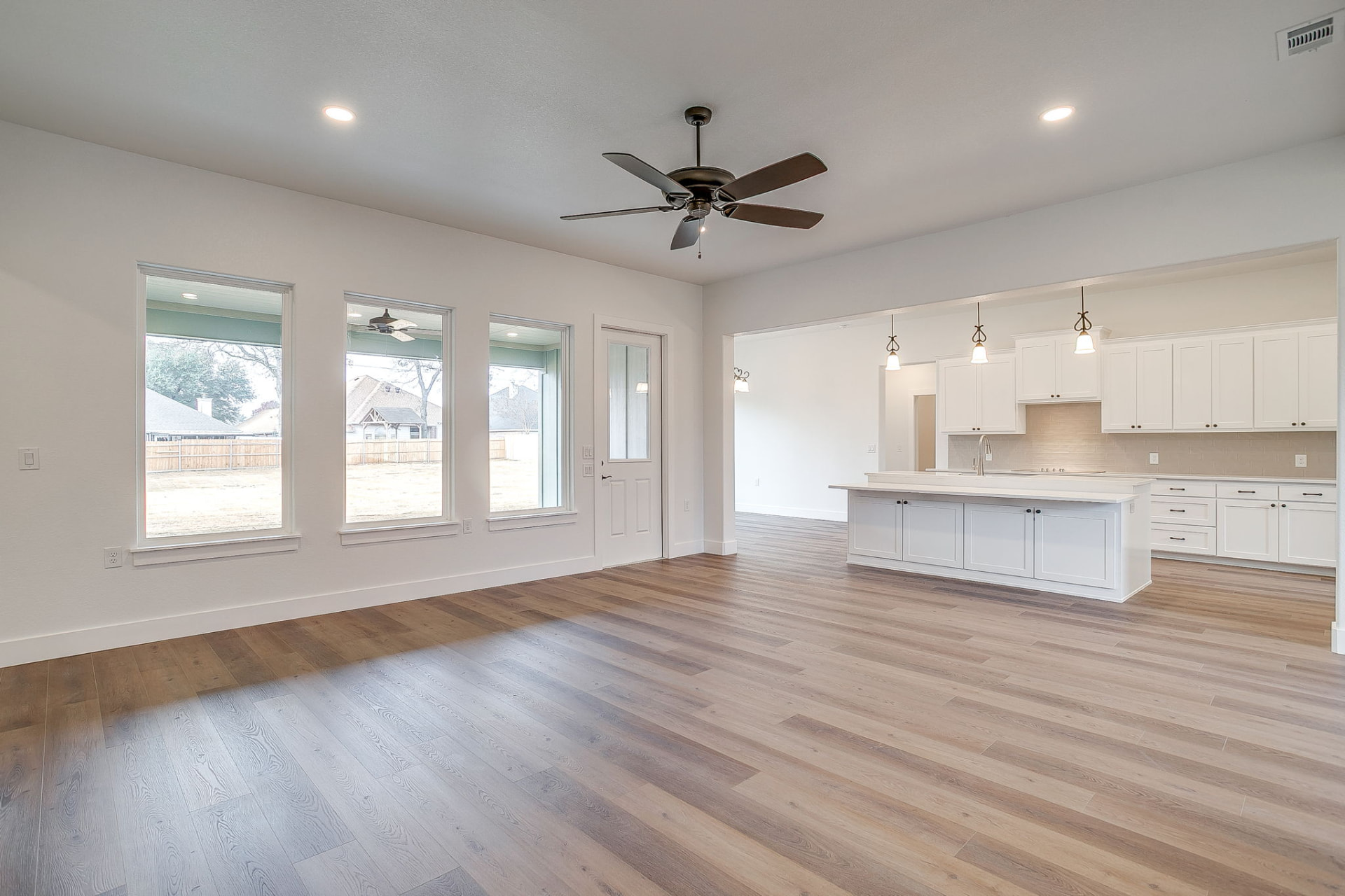 White custom kitchen with marble-topped island and shaker cabinetry