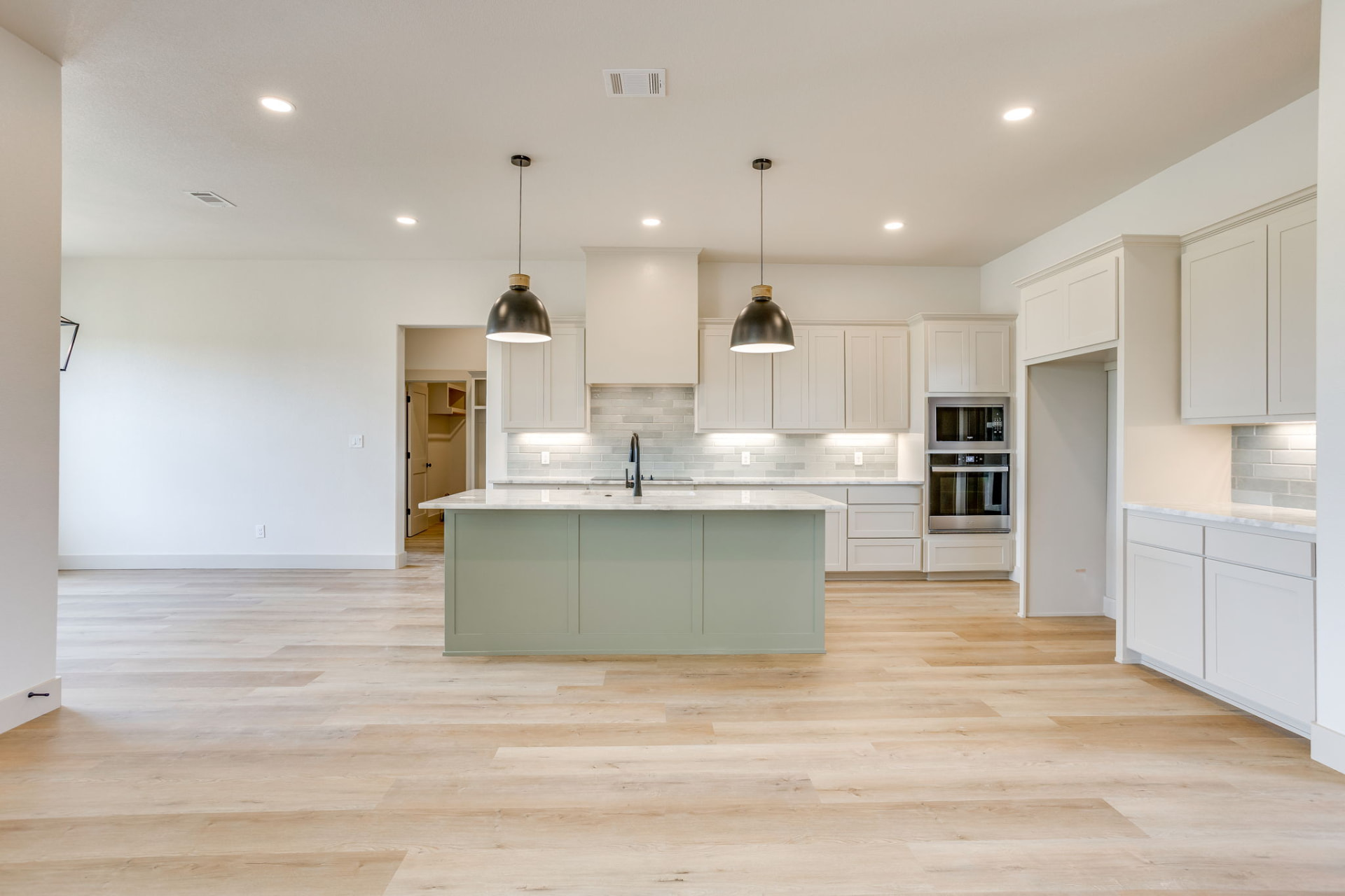 Wide view of the open-concept kitchen and living space