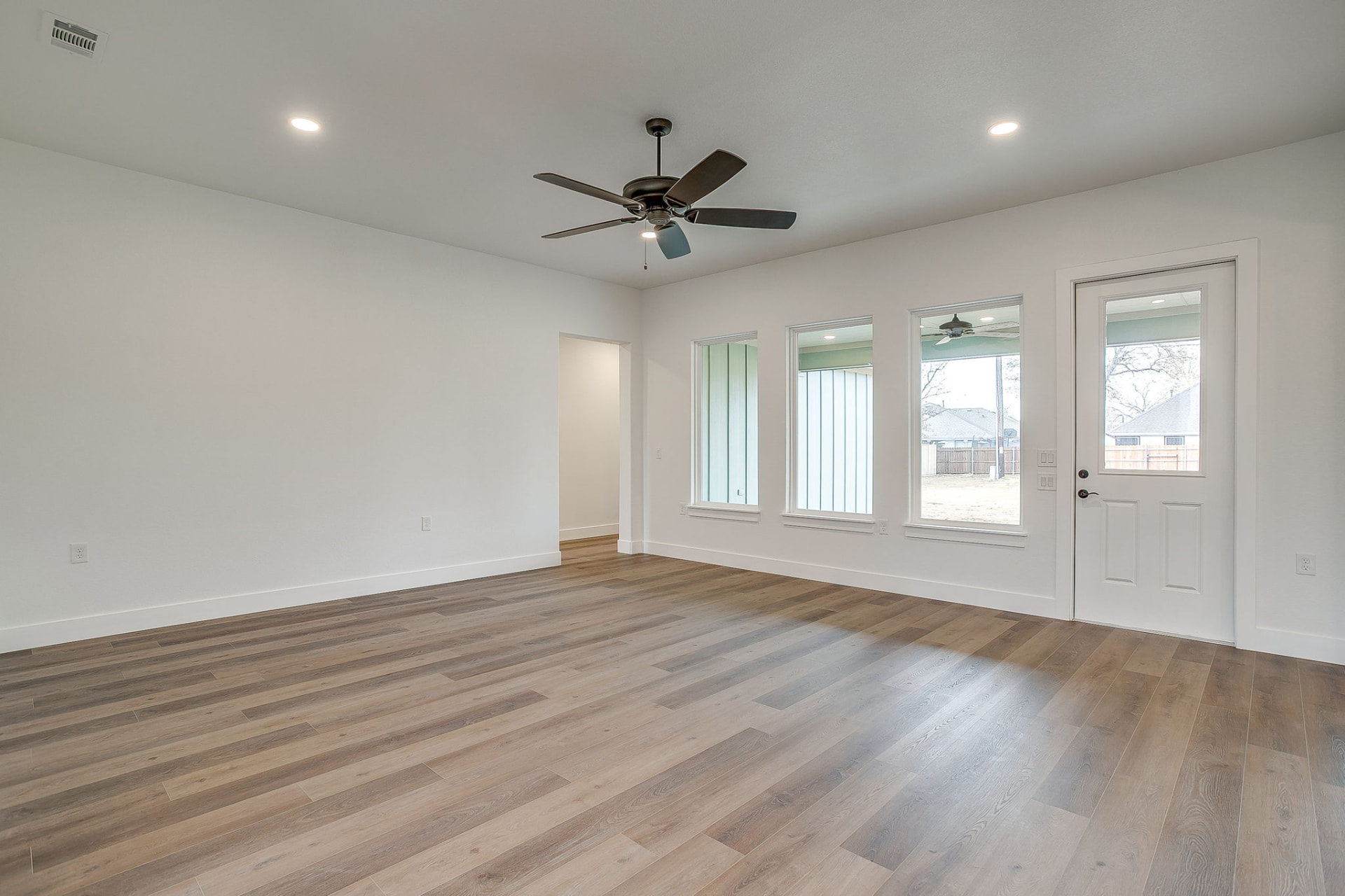 Great room and dining area with large windows and natural light