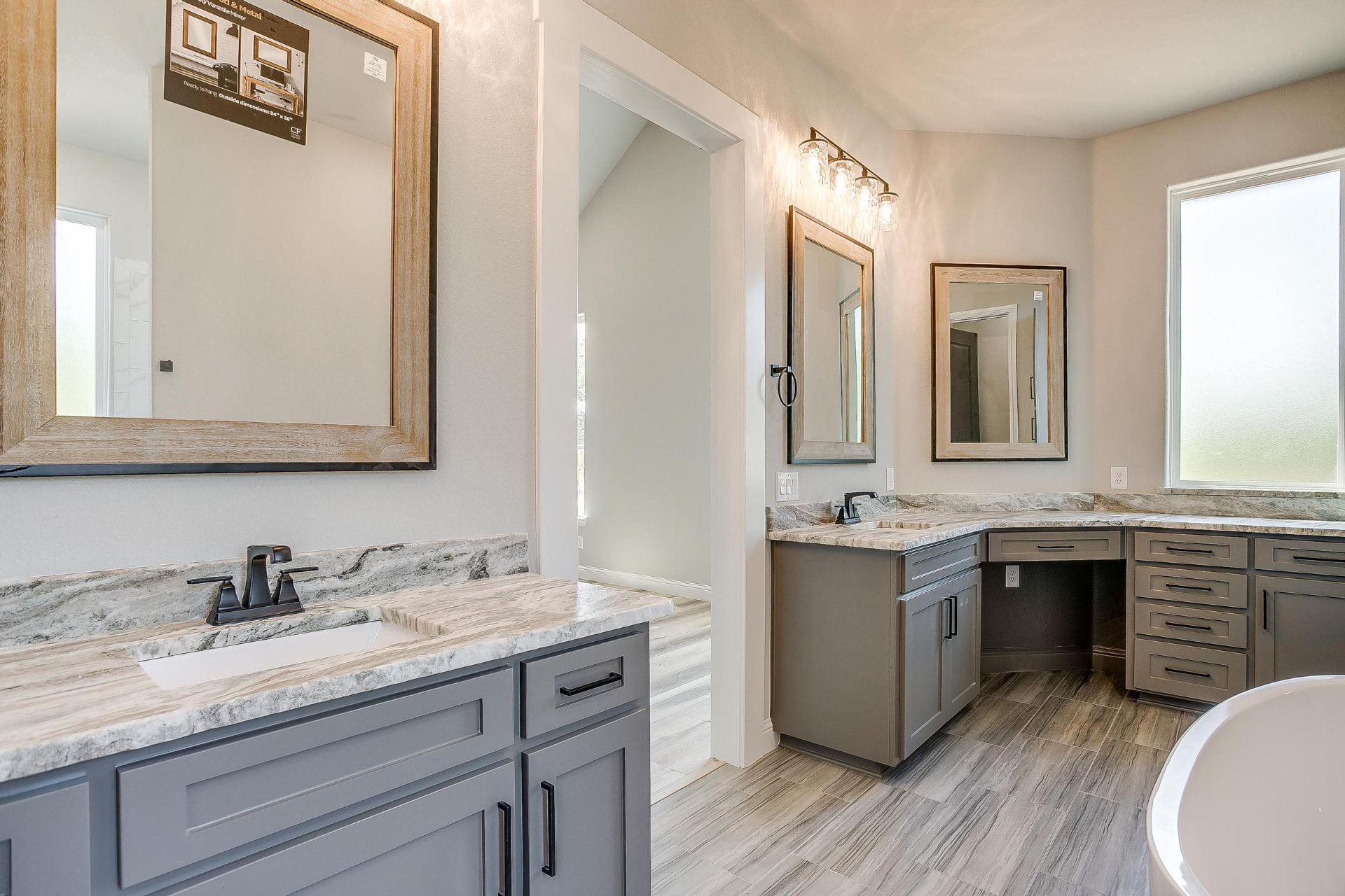 Primary bath vanity looking toward the makeup counter and window