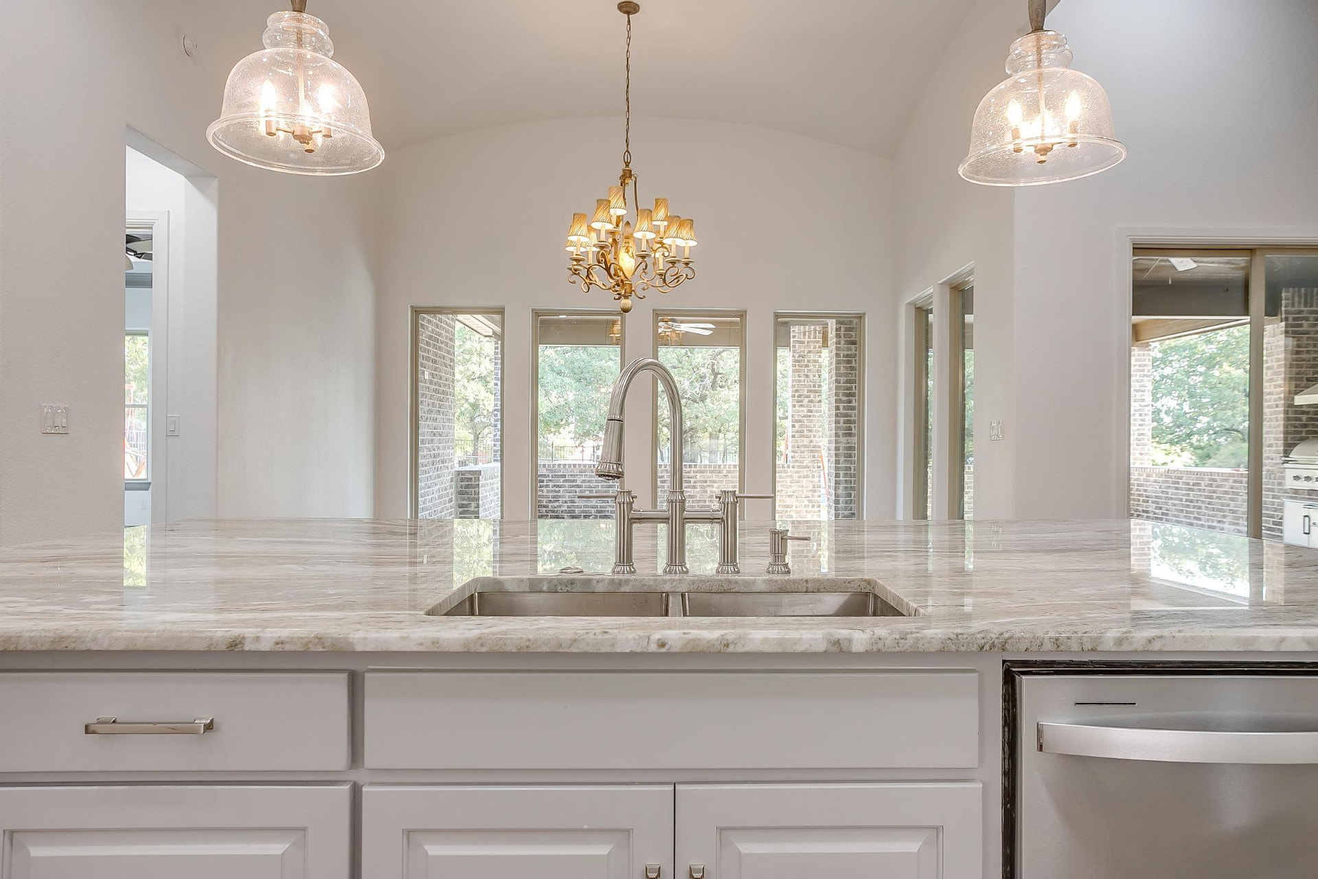 Kitchen sink looking out to large rear windows