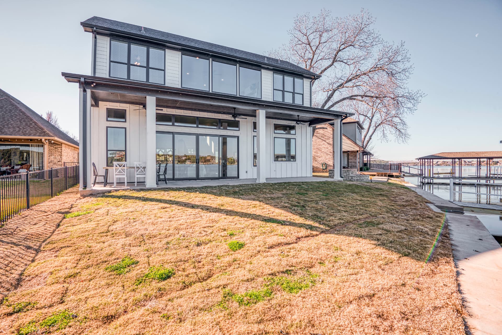 Side exterior with a grassy slope down to the lake