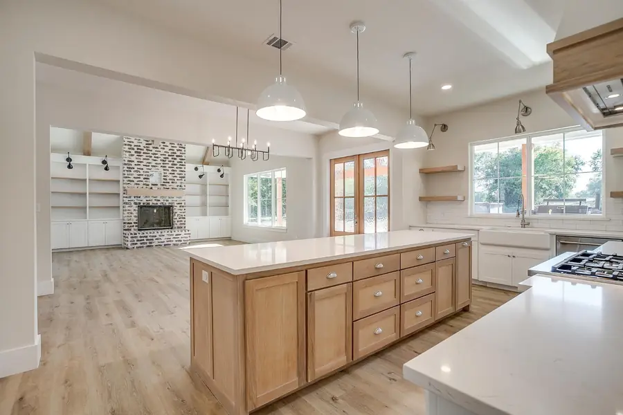 Wide kitchen view with the island opening to the living room