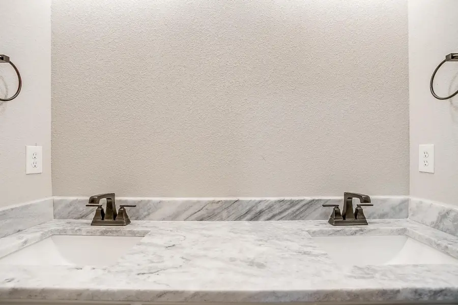 Double sinks and marble countertop in the guest bath