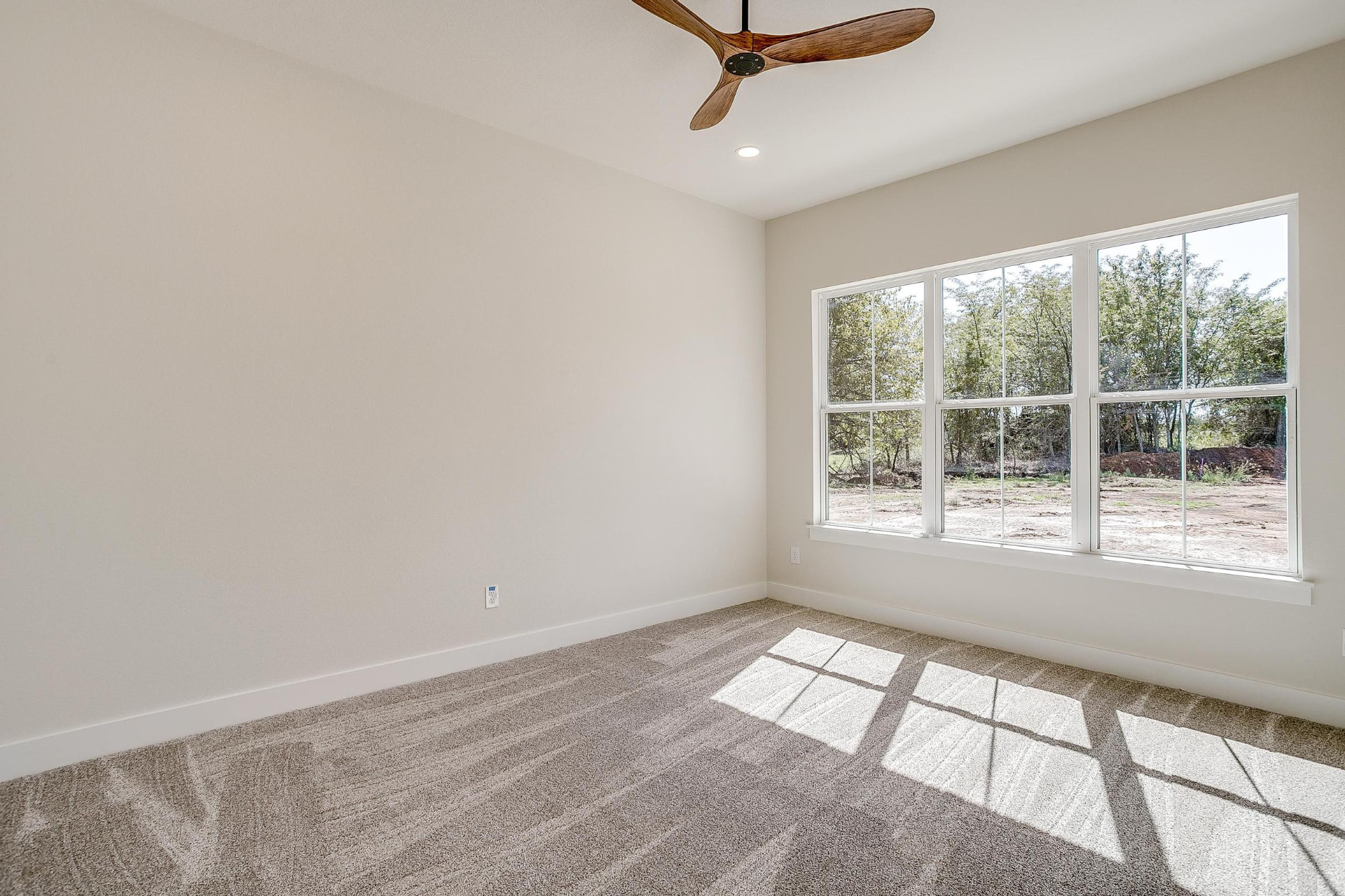 Bright bedroom with natural light and neutral walls