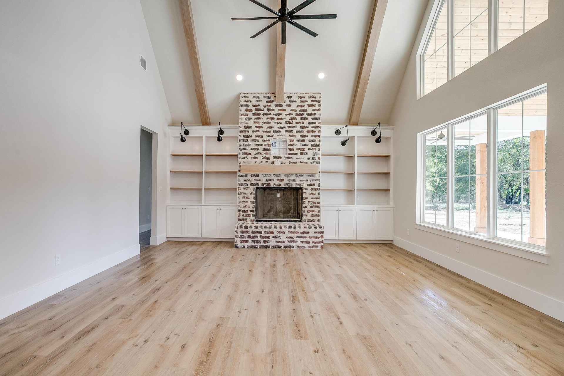 Wide living room view with high ceilings and large windows