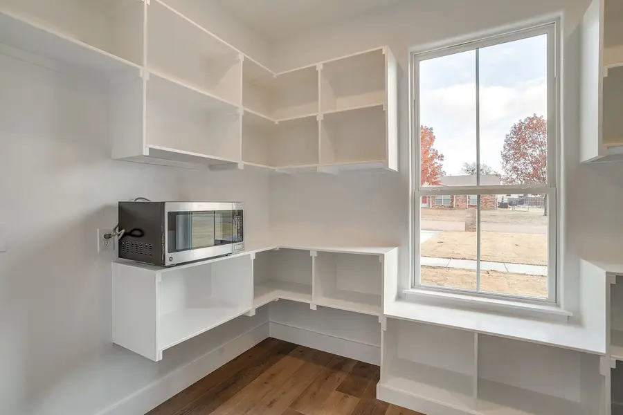 Secondary bedroom with large window and neutral finishes