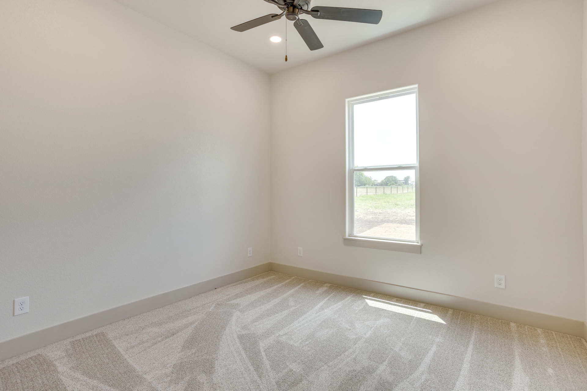 Bedroom with plush carpet and a ceiling fan