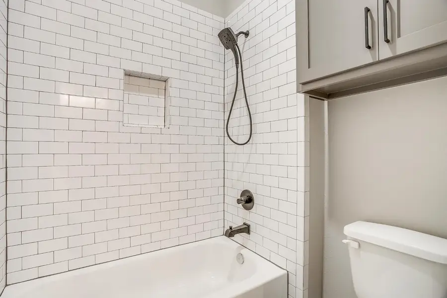 Tub and shower combination with white subway tile