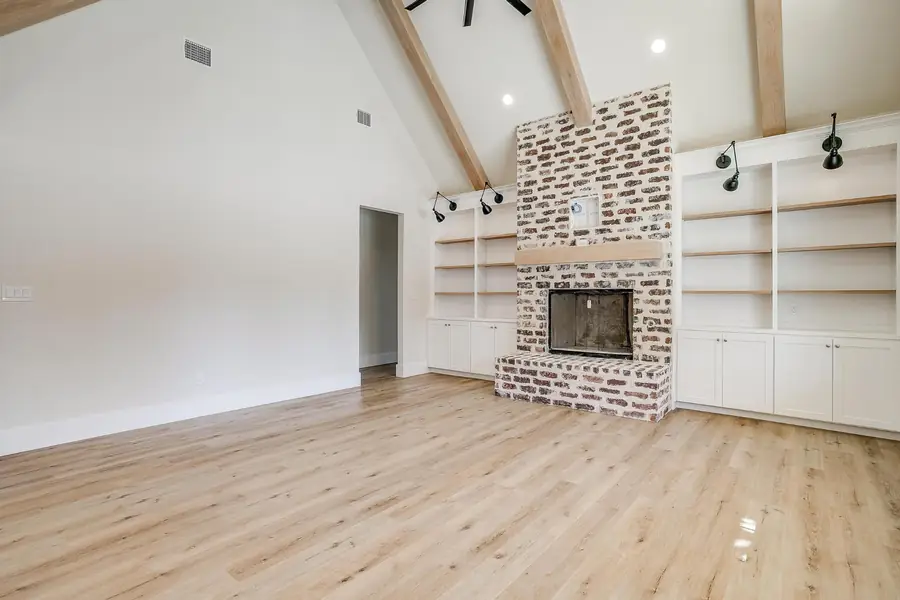 Living space with light wood flooring and clean white walls